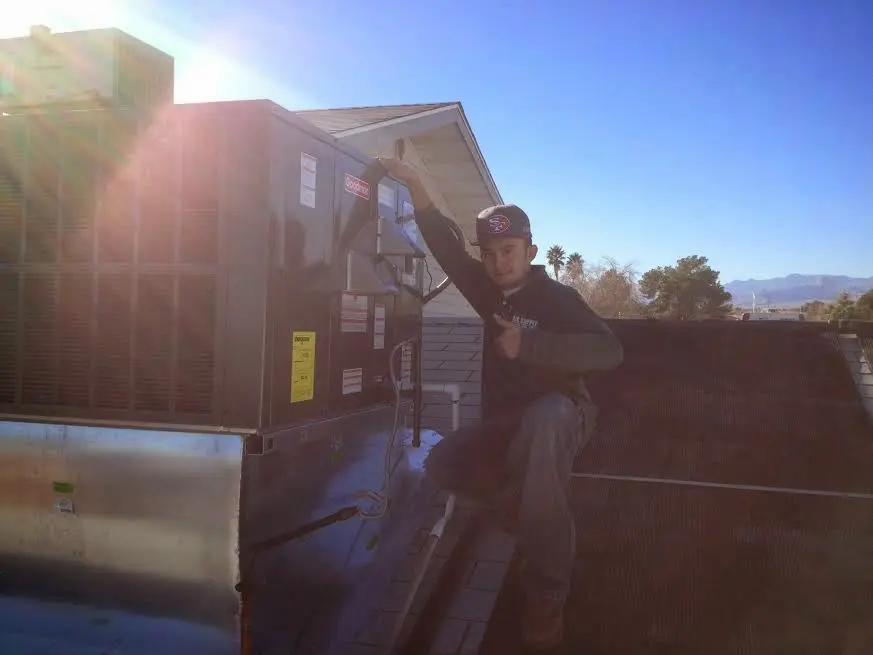 HVAC technician performing HVAC Inspection on a rooftop unit in New Hanover